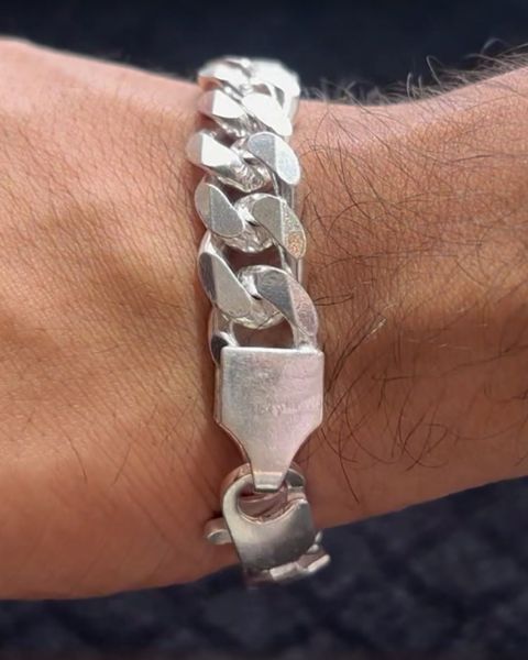 Heavy pure silver link bracelet on a wrist